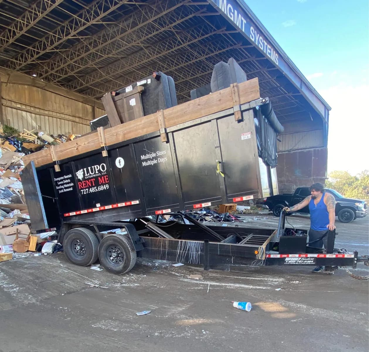 Lupo dumpster trailer tipping its load at a disposal facility after a Pasco County rental